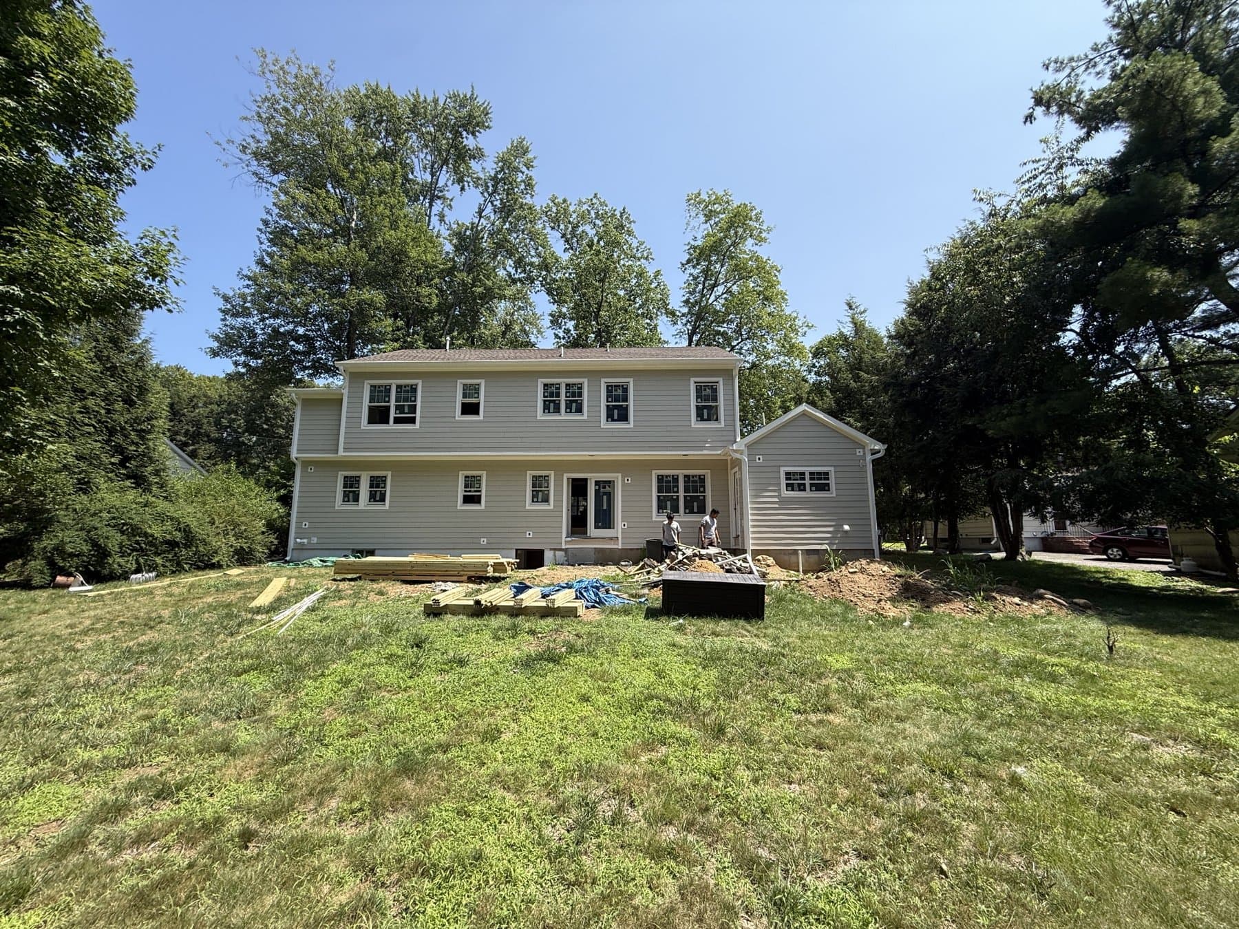 Hillside · After: The back of the same house finished, with new siding, new windows and a rear gable wing.
