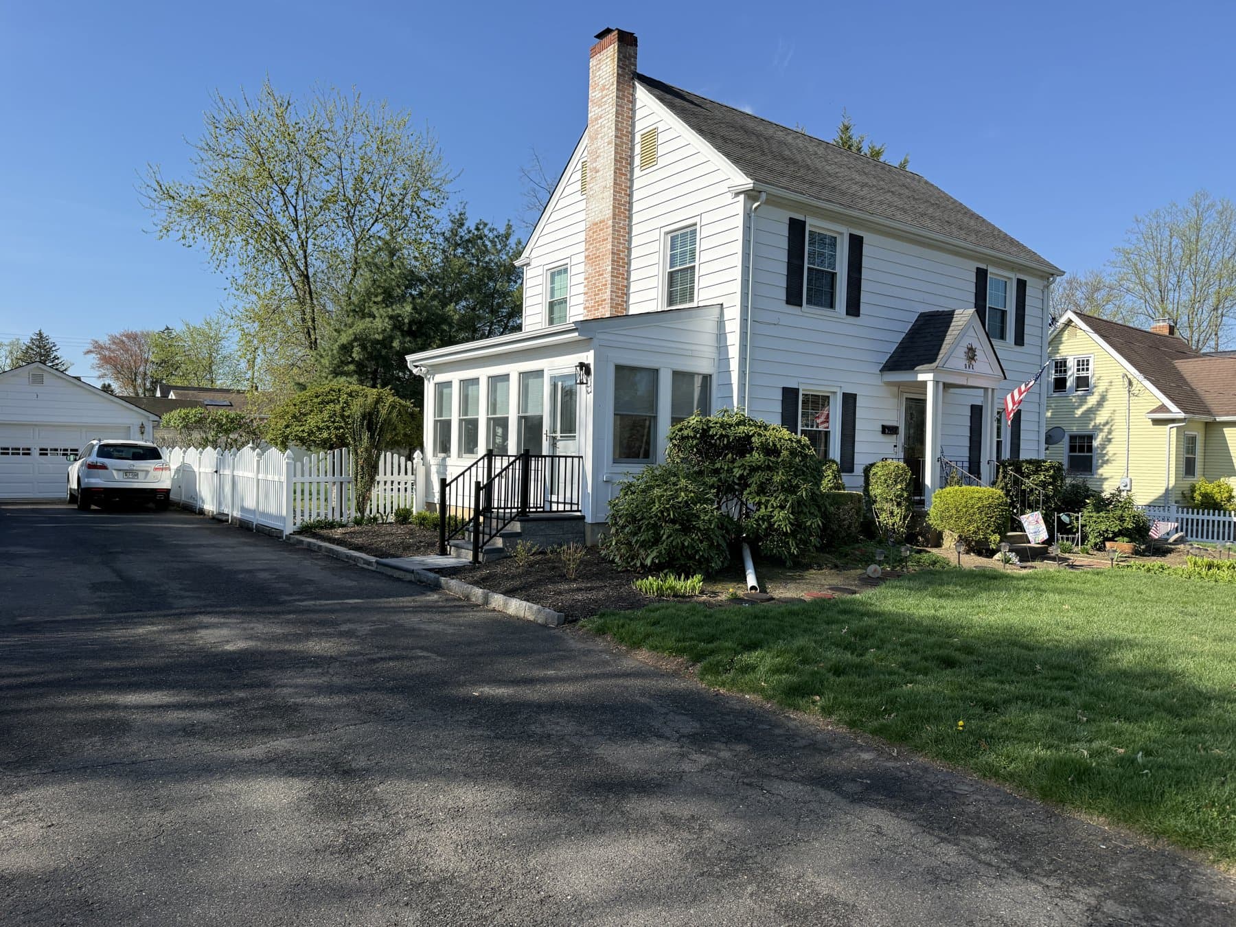 Barkalow from the driveway, with the new sunroom on the side and the portico over the front door.