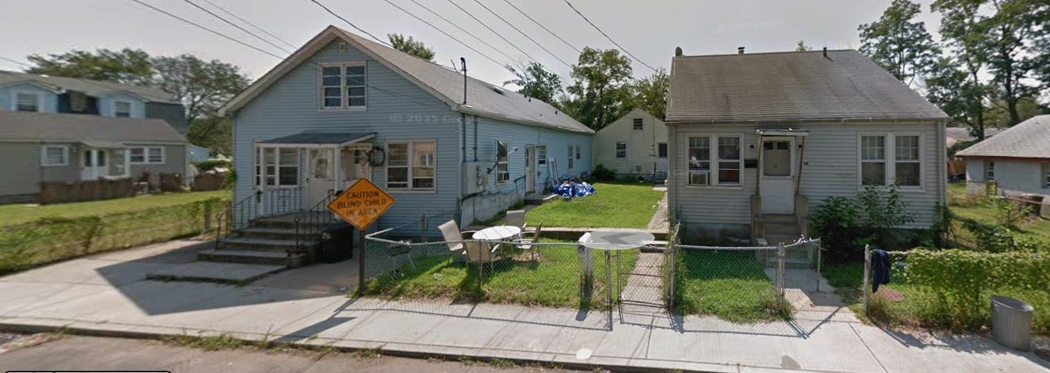 Before: Older bungalows side by side behind a chain-link fence.